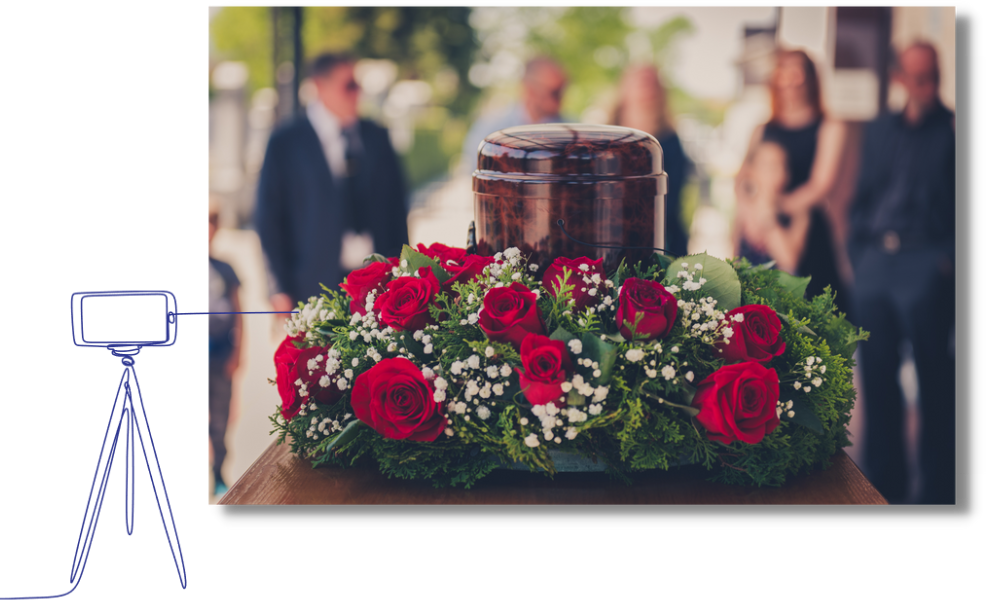 Urn and roses at a funeral service with guests