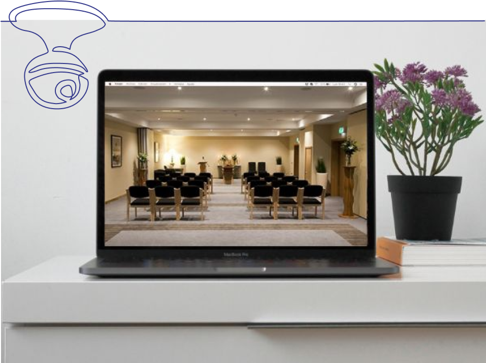 Funeral service live stream on a laptop displayed on desk with flowers and books Funeral service live stream on a laptop displayed on desk with flowers and books