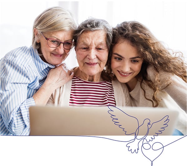 Three family memebers watching a funeral service stream on a laptop 