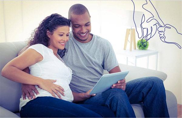 Young couple on a couch watching a funeral service stream on a tablet 